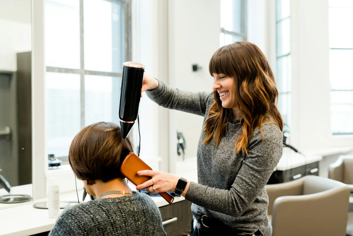 Example: Jenny, a hairdresser, blow-drying a client's hair