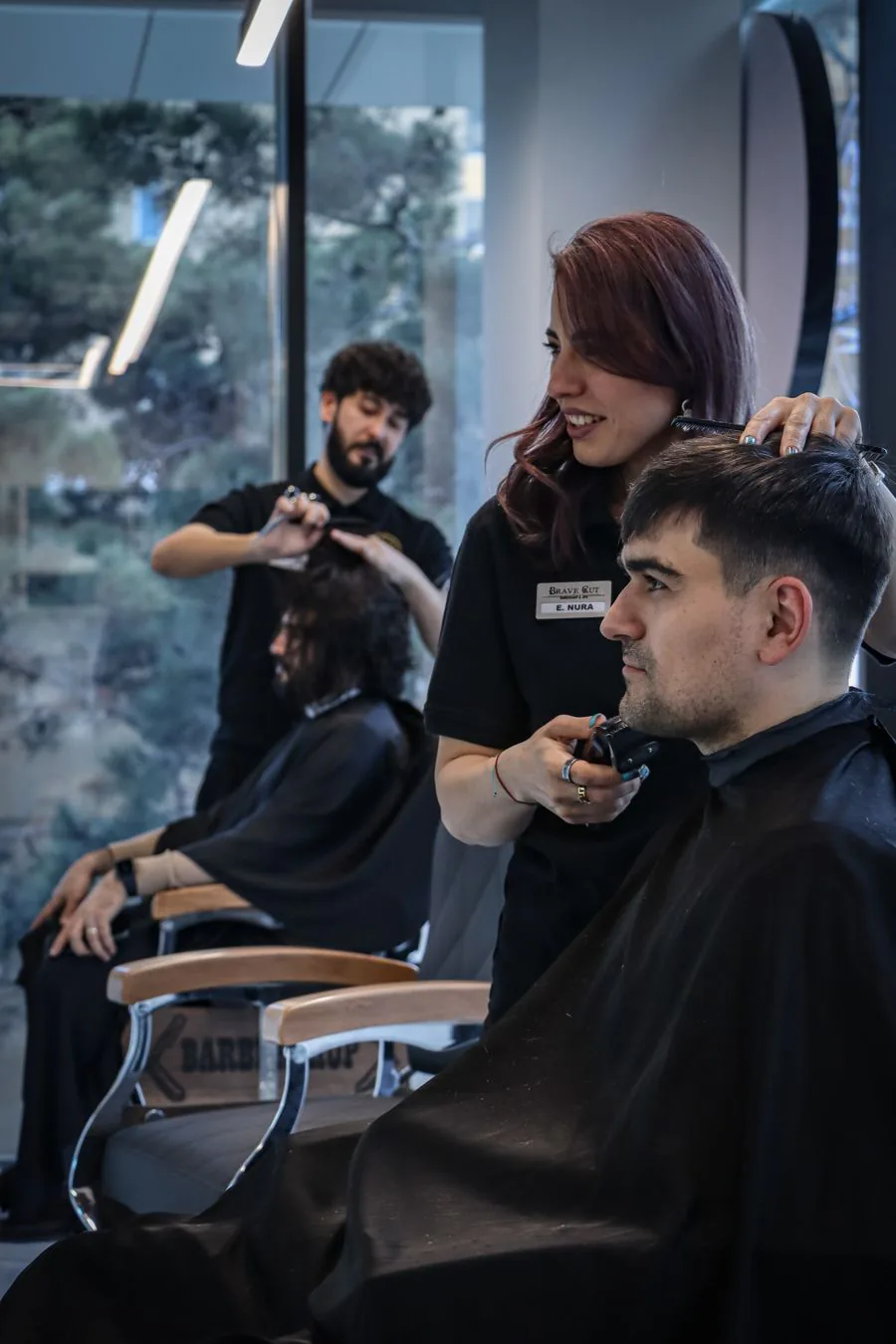 A busy salon floor with two stylists working on clients