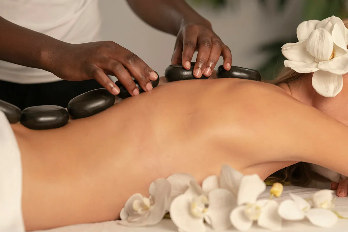 A therapist placing warm stones during a massage